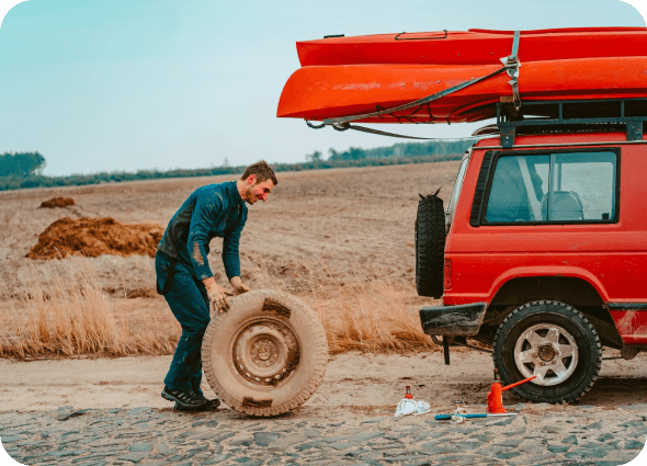 guy smiling changing a tyre